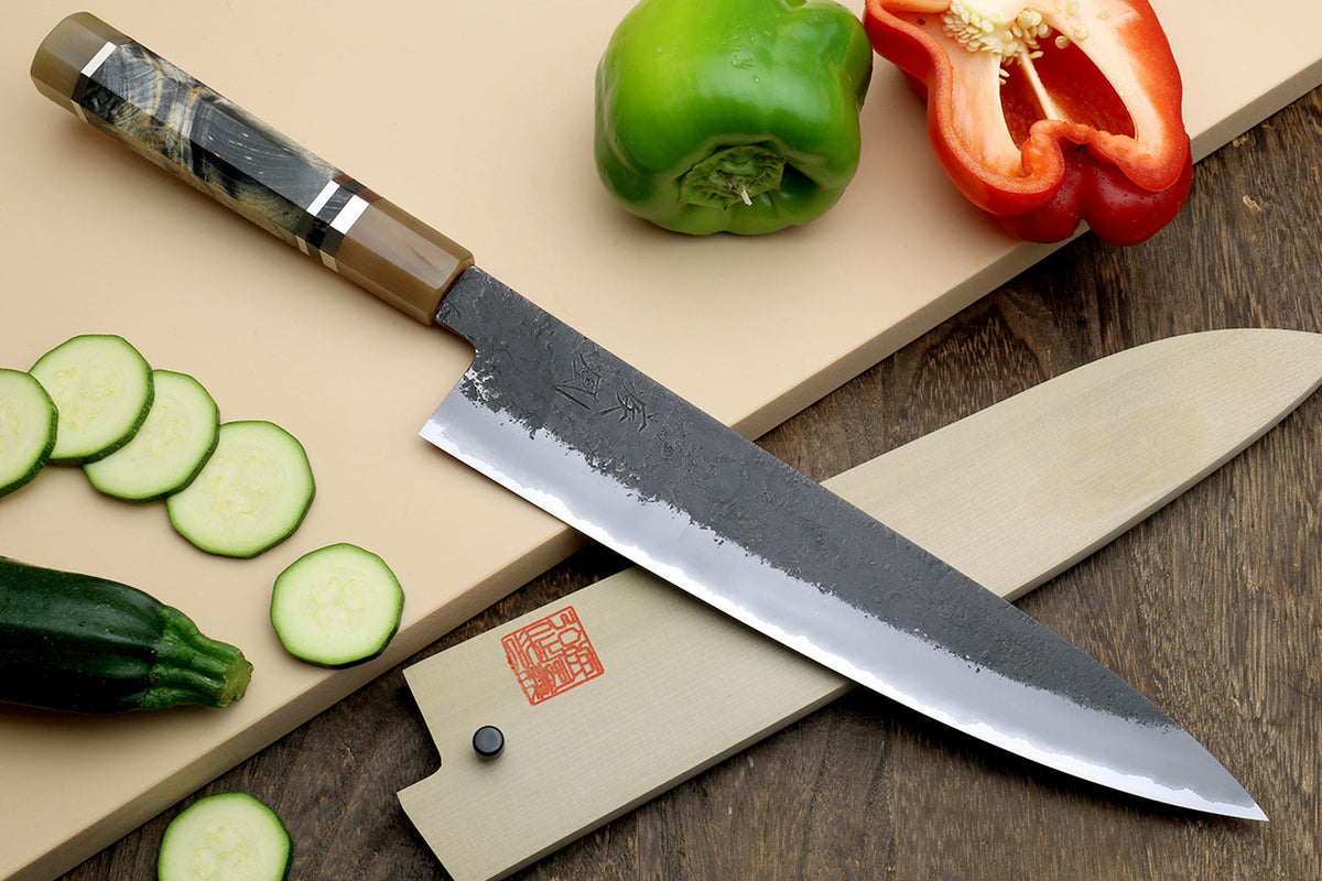 Japanese gyuto chef's knife on a wooden cutting board