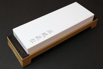 8000-grit sharpening whetstone, white rectangular stone on tan base with black insert
