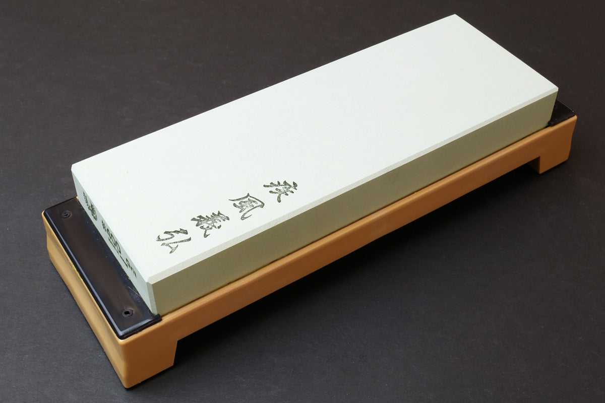 400-grit sharpening whetstone with white stone on beige base, metal-side holes
