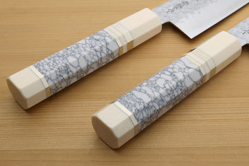 Gyuto chef knife handle close-up with white crackle pattern and ivory bolster