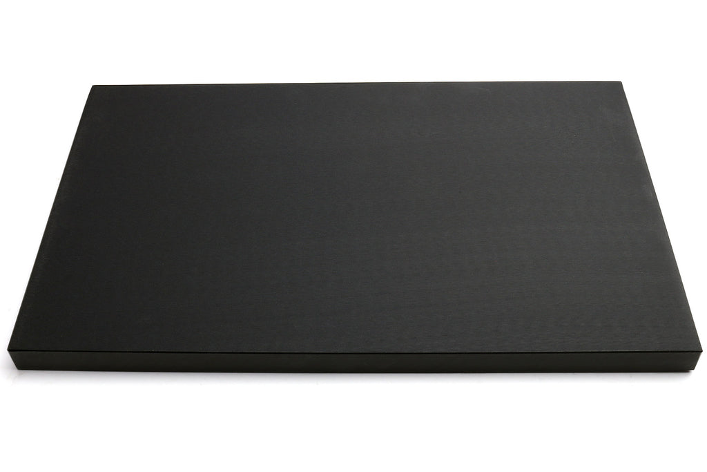 Black cutting board, smooth matte top surface, front view