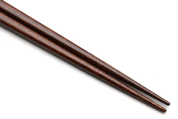 Pair of dark brown lacquered chopsticks with tapered ends