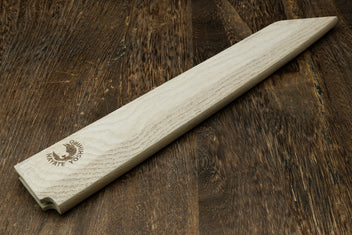 Light oak wooden saya cover with pointed tip and brand logo, side view