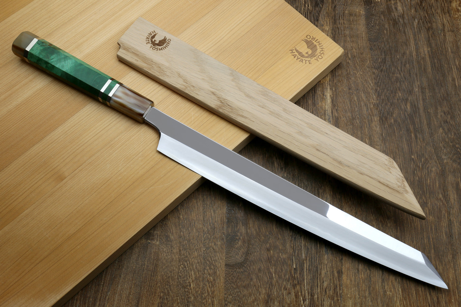 Ginsan Stainless Steel Yanagi Kiritsuke Slicer with magnetic wooden sheath on a utting board