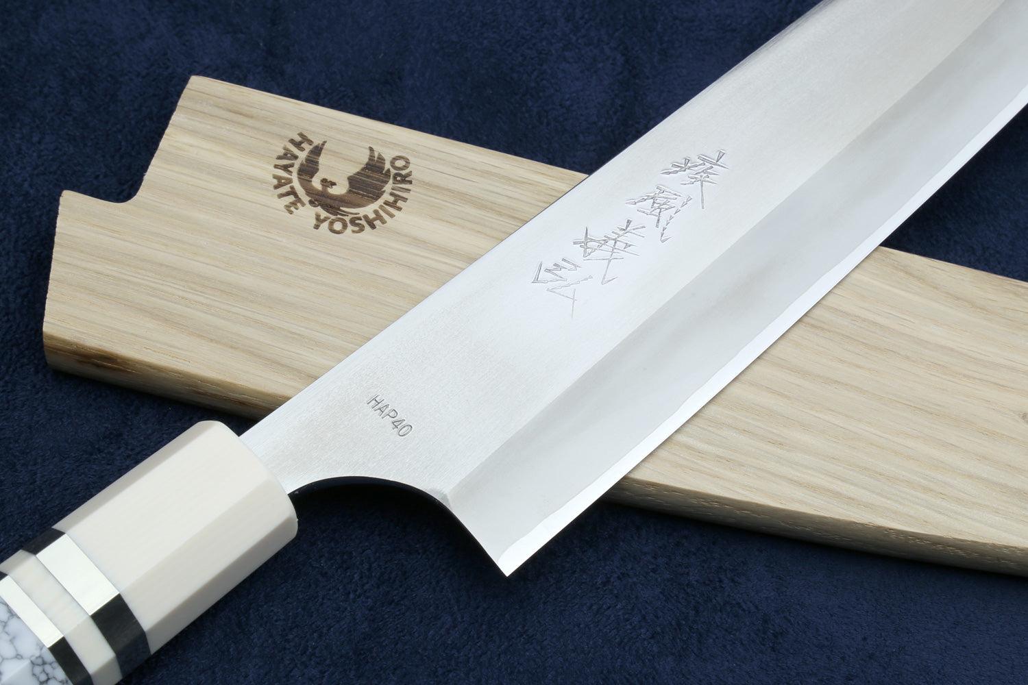 Japanese knife with a wooden sheath on a dark background