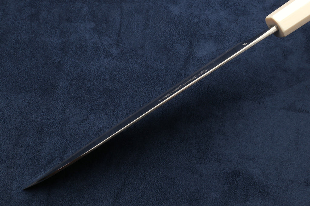 Knife with a water buffalo horn bolster handle on a dark blue background