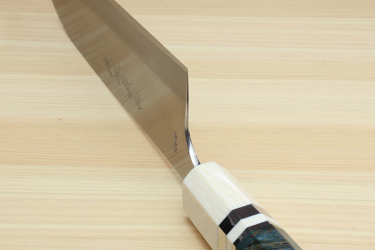 Santoku chef's knife blade edge and dark blue handle with ivory bolster