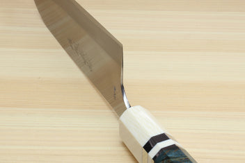 Santoku chef's knife blade edge and dark blue handle with ivory bolster