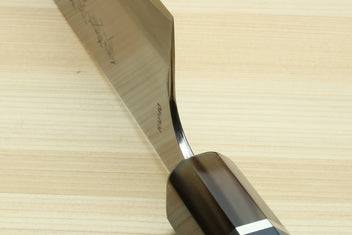 Santoku chef's knife tip close-up with stamped markings on white blade and dark handle