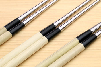 Set of sushi tweezers with light wood handles, black collars, and stainless points