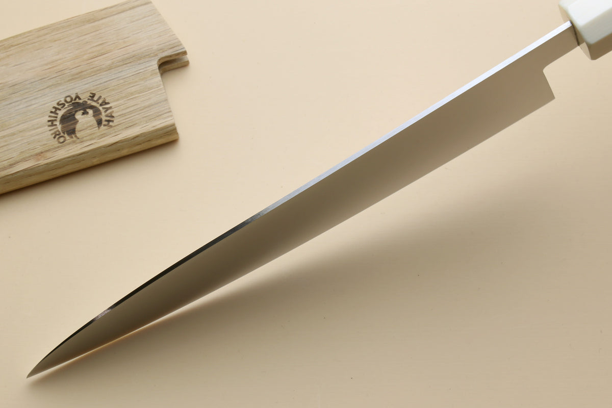 Japanese gyuto knife tip with smooth white blade and dark bolster transition