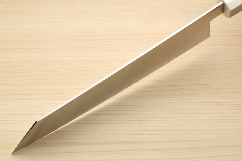 Kiritsuke chef knife blade side, showing spine curve and white bolster on rosewood handle.