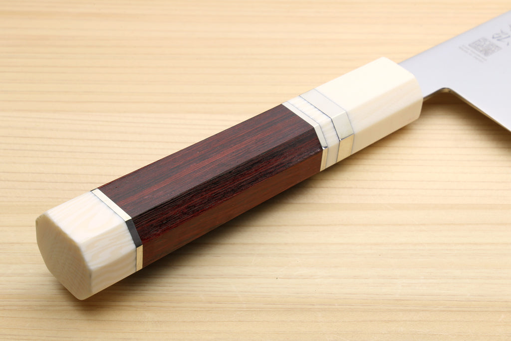 Rosewood handle end with white bolster; white Kiritsuke chef knife blade in view.