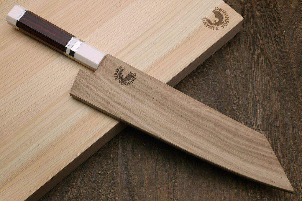 Kiritsuke chef knife crossed on boards, white stainless blade, rosewood handle, ivory-look bolster.