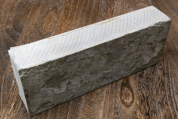 Natural sharpening whetstone block, dark gray side with textured surface