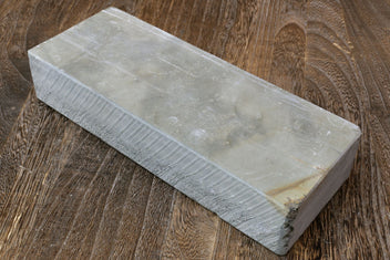 Natural sharpening whetstone, pale gray rectangular stone block with straight edges