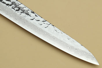 Damascus steel knife blade close-up with wave-pattern steel texture