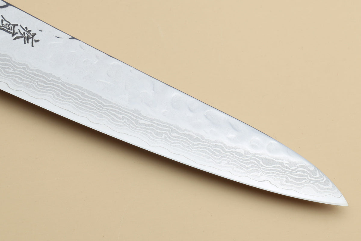 Damascus steel knife blade close-up with wave-pattern steel texture