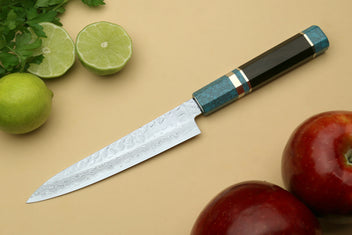 Petty utility chef knife shown in profile, with Damascus blade and blue handle.
