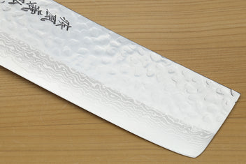 White howlite-handled nakiri knife, hammered Damascus blade edge close-up