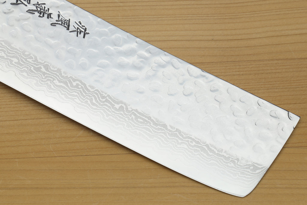 Nakiri vegetable knife blade face with hammered Damascus texture and silver finish