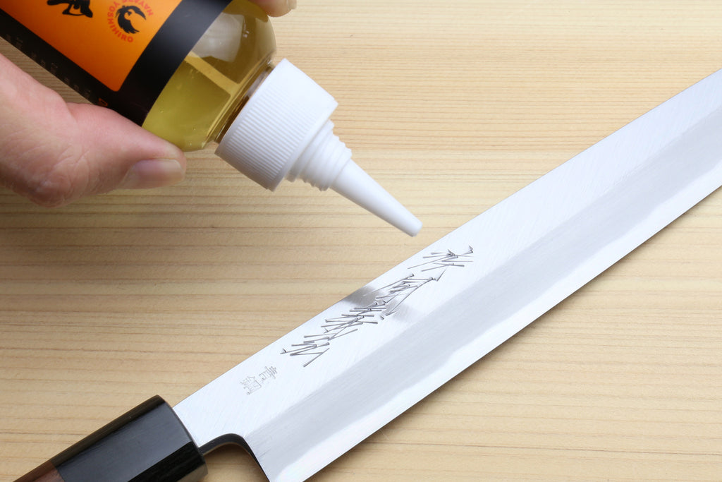 Applying Tsubaki camellia oil to a Japanese knife blade to prevent rust