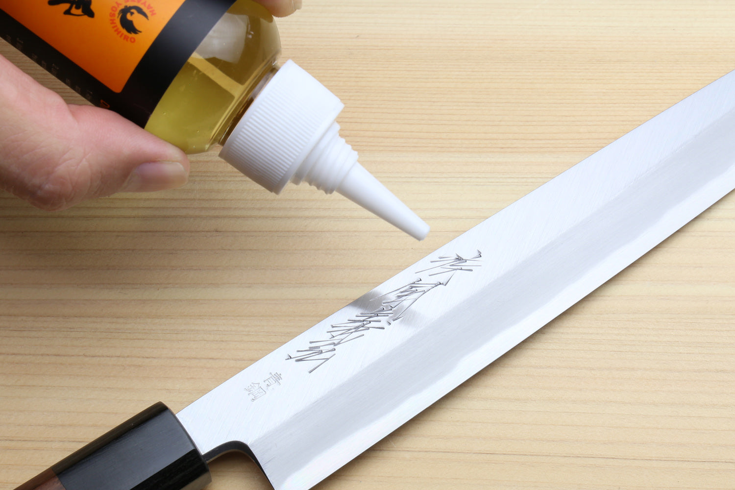 Applying Tsubaki camellia oil to a Japanese knife blade to prevent rust