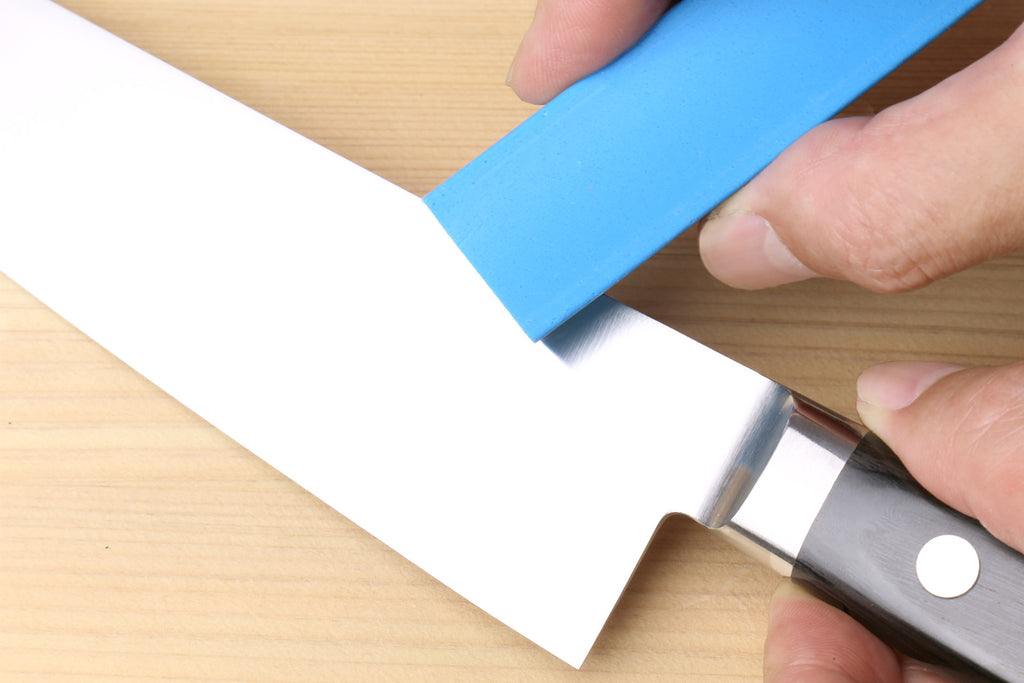 Sabitori rust eraser removing rust spots from a Japanese knife blade