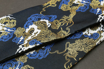 Black dragon-pattern knife pouch bag close-up with gold, blue and white embroidered dragons