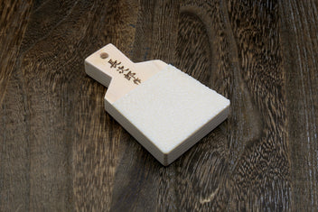 Japanese sharkskin grater block with white textured face and light wood handle