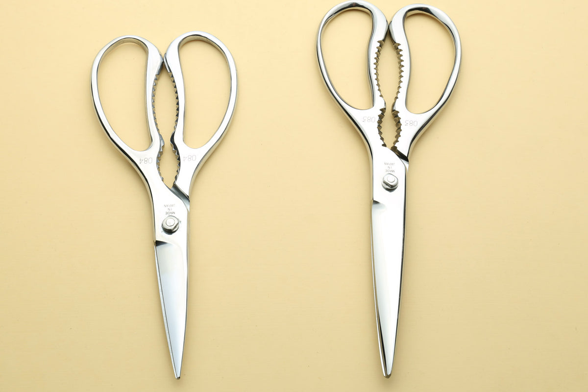 Pair of stainless steel kitchen shears with loop handles and pointed tips
