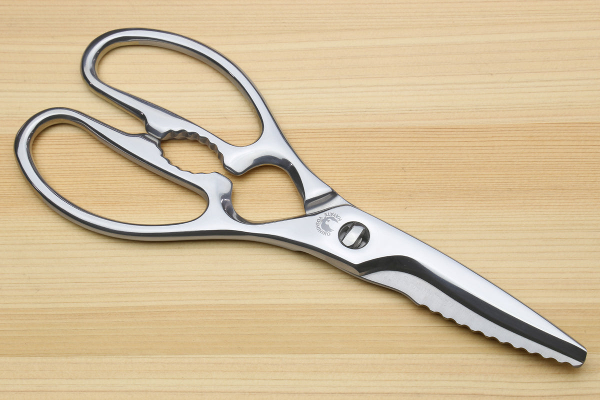 Stainless steel kitchen shears with serrated blades and oval loop handles.