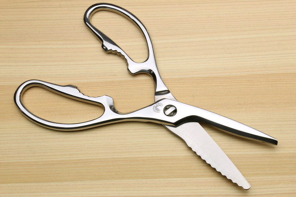 Stainless steel kitchen shears with serrated blade tips and oval loop handles.