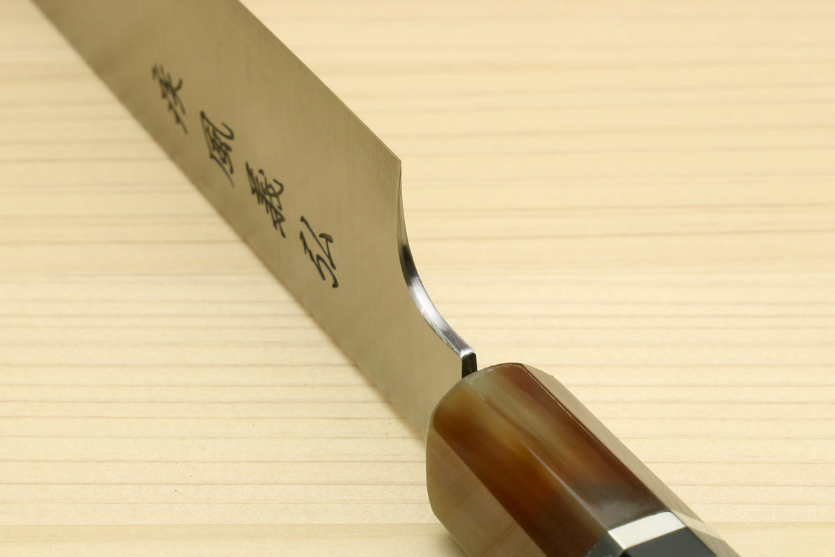 Sujihiki-kiritsuke knife close-up with engraved blade heel and dark wooden grip