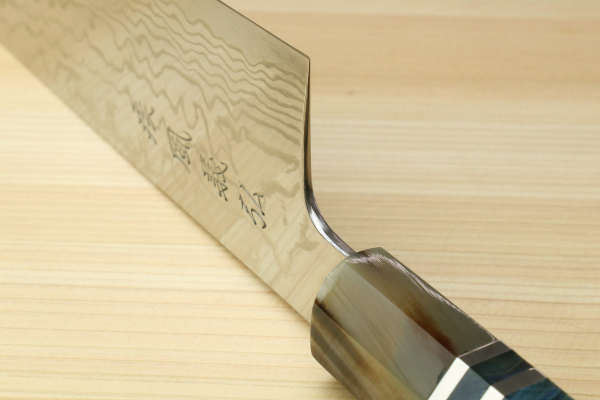Gyuto chef knife heel close-up with damascus blade and ocean blue handle