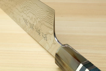 Gyuto chef knife heel close-up with damascus blade and ocean blue handle