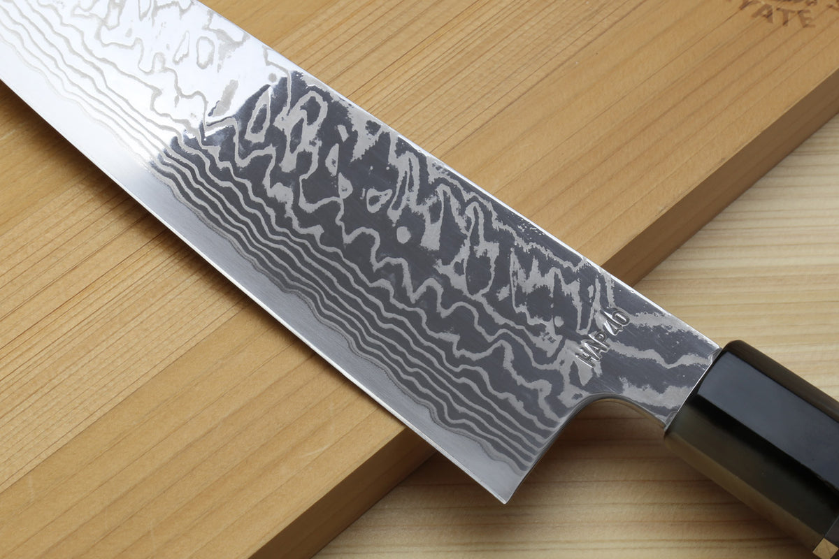 Damascus blade close view on kiritsuke chefs knife with ocean blue handle