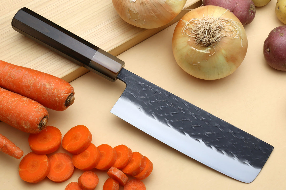 Nakiri and petty knives with dark patterned blades and silver cutting surfaces