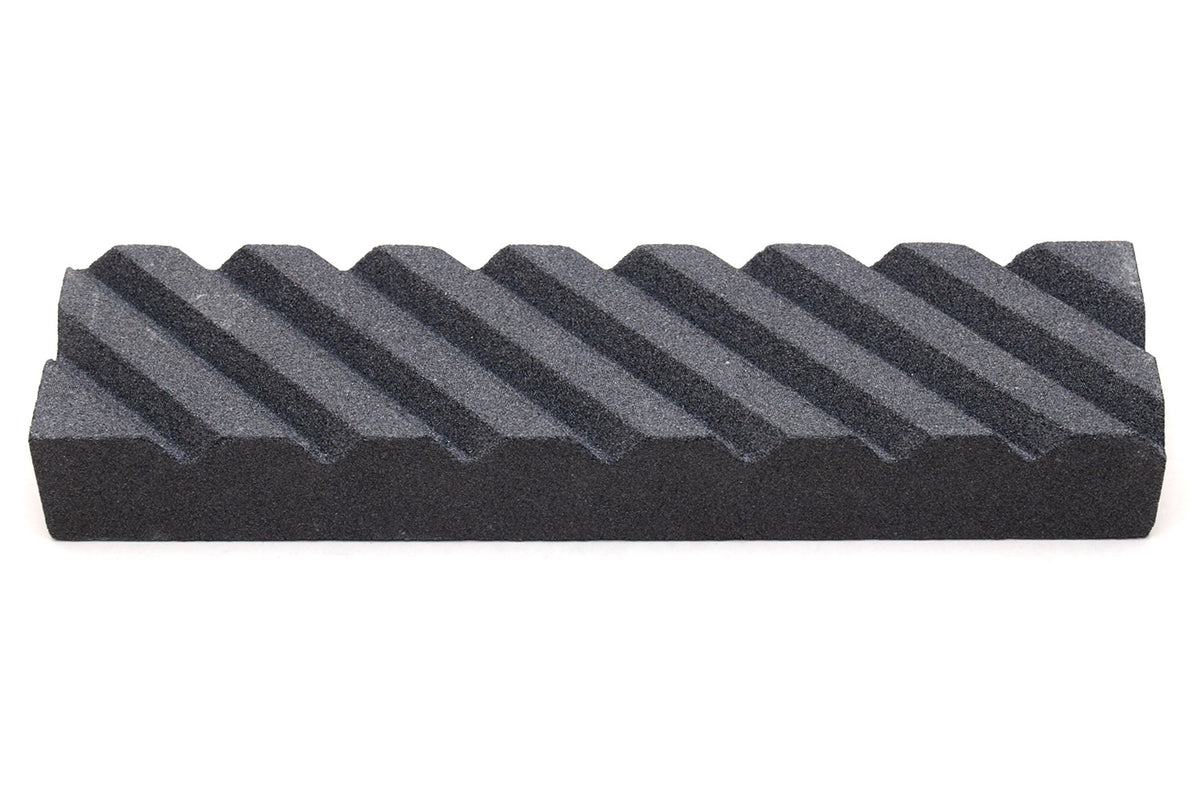 Black stone fixer block with ridged surface for sharpening and conditioning tools