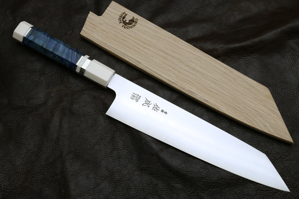 ZDP189 steel knife with a wooden sheath on a dark Leather background