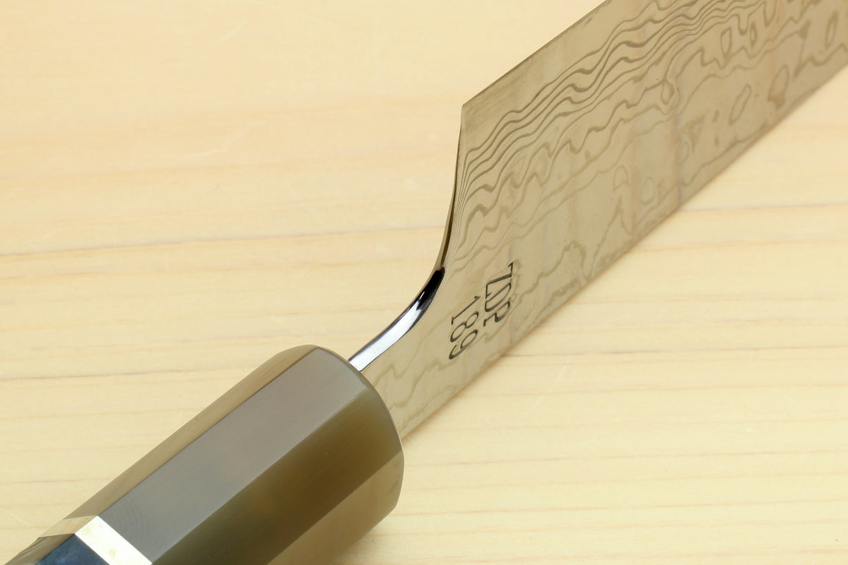 Chef gyuto knife close-up of Damascus blade and ocean blue octagonal handle