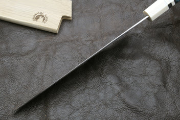 Damascus gyuto chef knife with silver-toned blade and ivory octagonal handle, side view