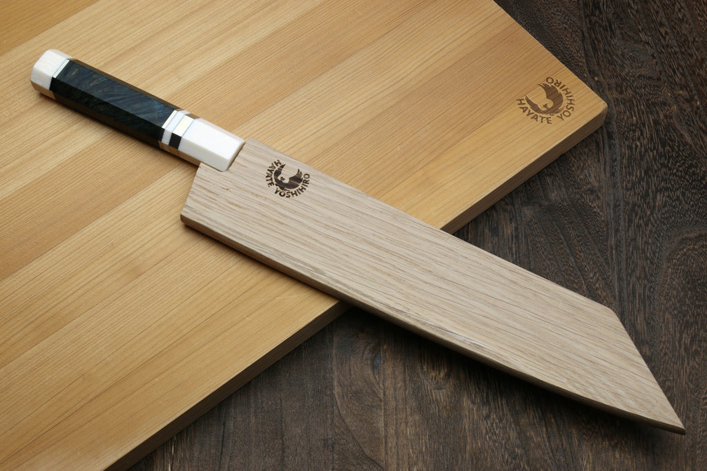 ZDP189 steel damascus  knife with a wooden handle on a wooden cutting board