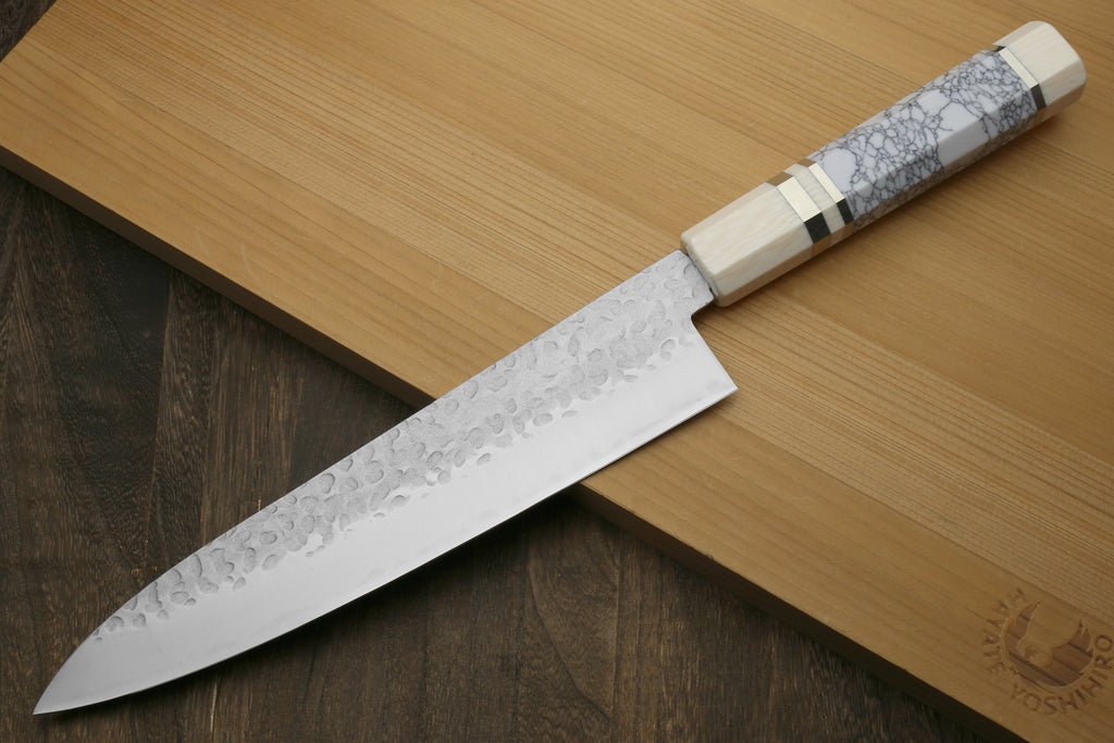 Chef's gyuto knife with white-gray crackle handle scales and hammered blade