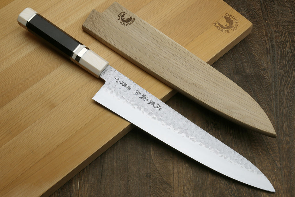 Super Blue steel Chef's knife with wooden sheath on a wooden surface