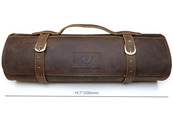 Brown leather knife roll case front view with two top handles and embossed center emblem.