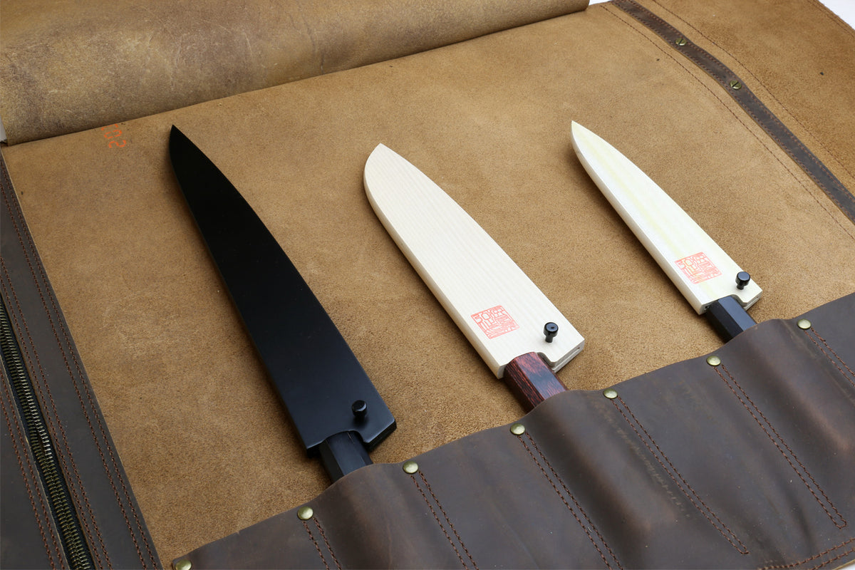 Brown leather knife roll case open, showing multiple knife slots and stitched panels.