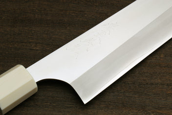 Close-up of gyuto knife blade edge with ivory bolster and ocean blue handle accent
