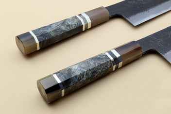 Nakiri vegetable knife with blue-gray Damascus-style handle and dark forged blade