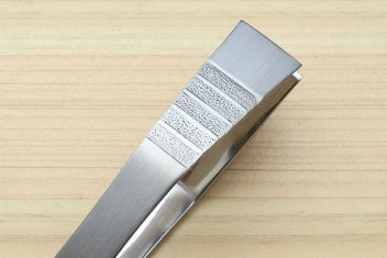 Non-slip fish bone tweezers close-up with textured grip panel on brushed metal.